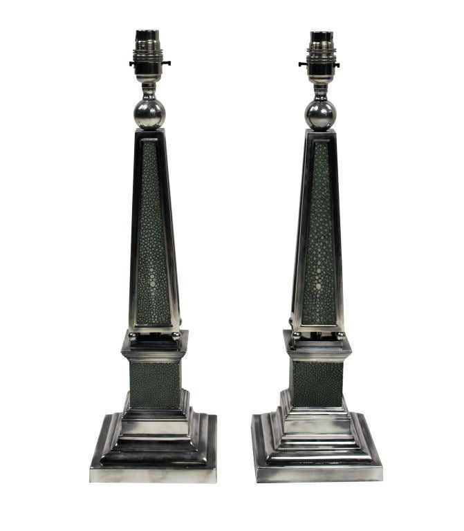 A pair of English silver plated obelisk lamps covered in antique shagreen.

 