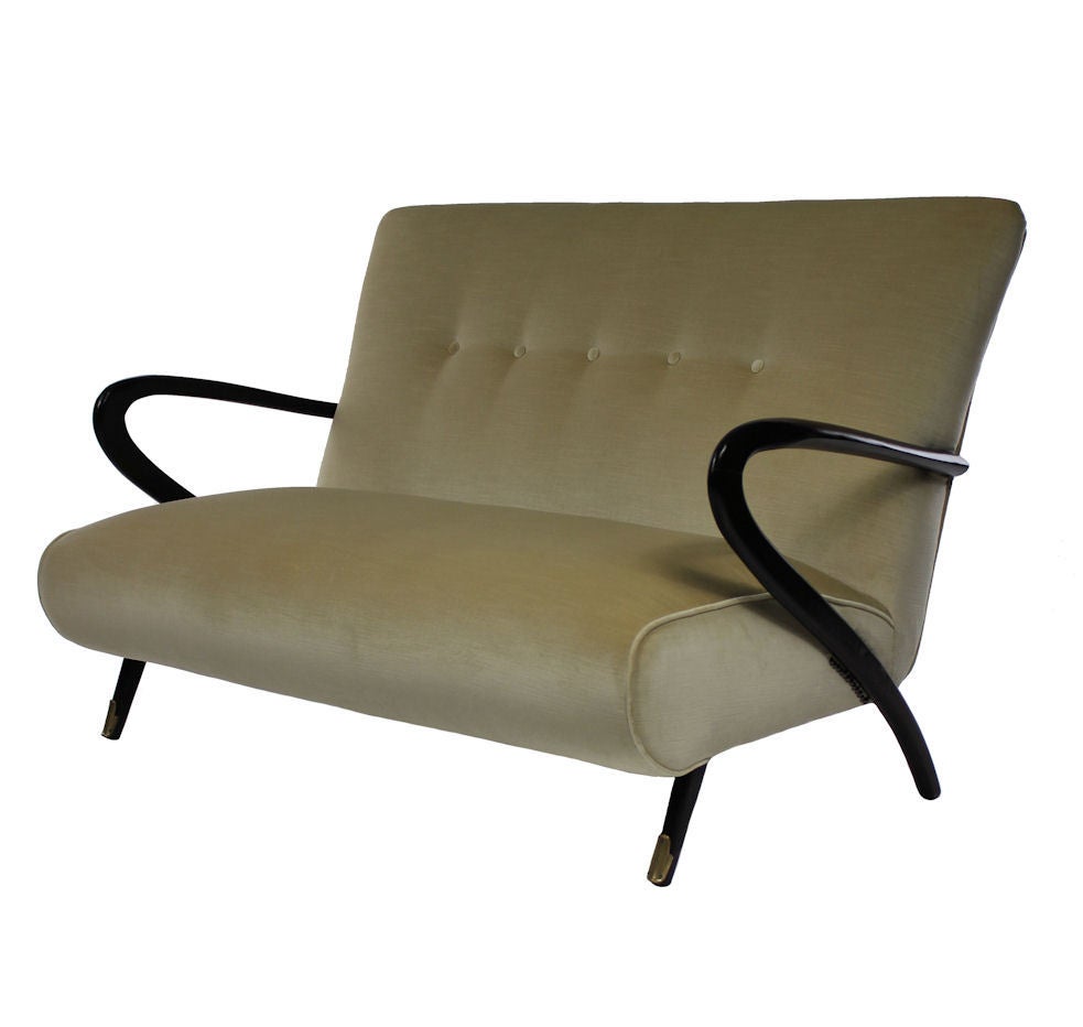 A stylish Italian Settee in the styleof Paolo Buffa of Milan with sculptural rosewood arms and brass sabot feet. Newly upholstered in ribbed champagne velvet.