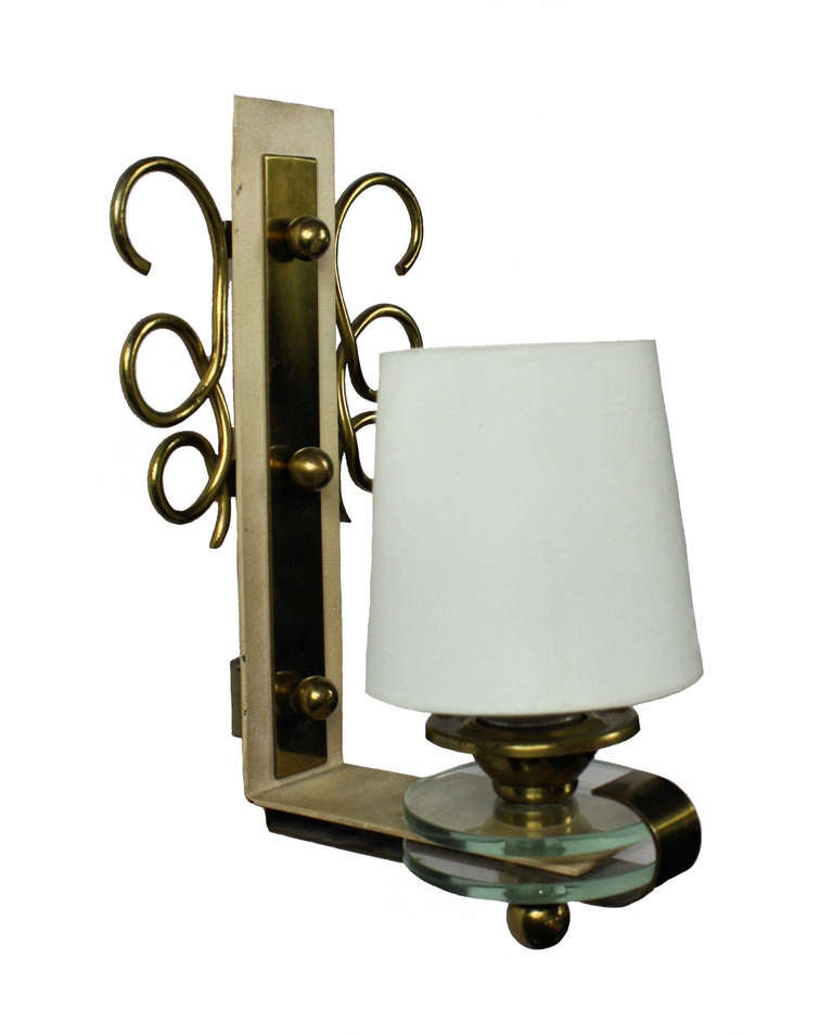 A pair of French wall lights in brass and glass of interesting design.