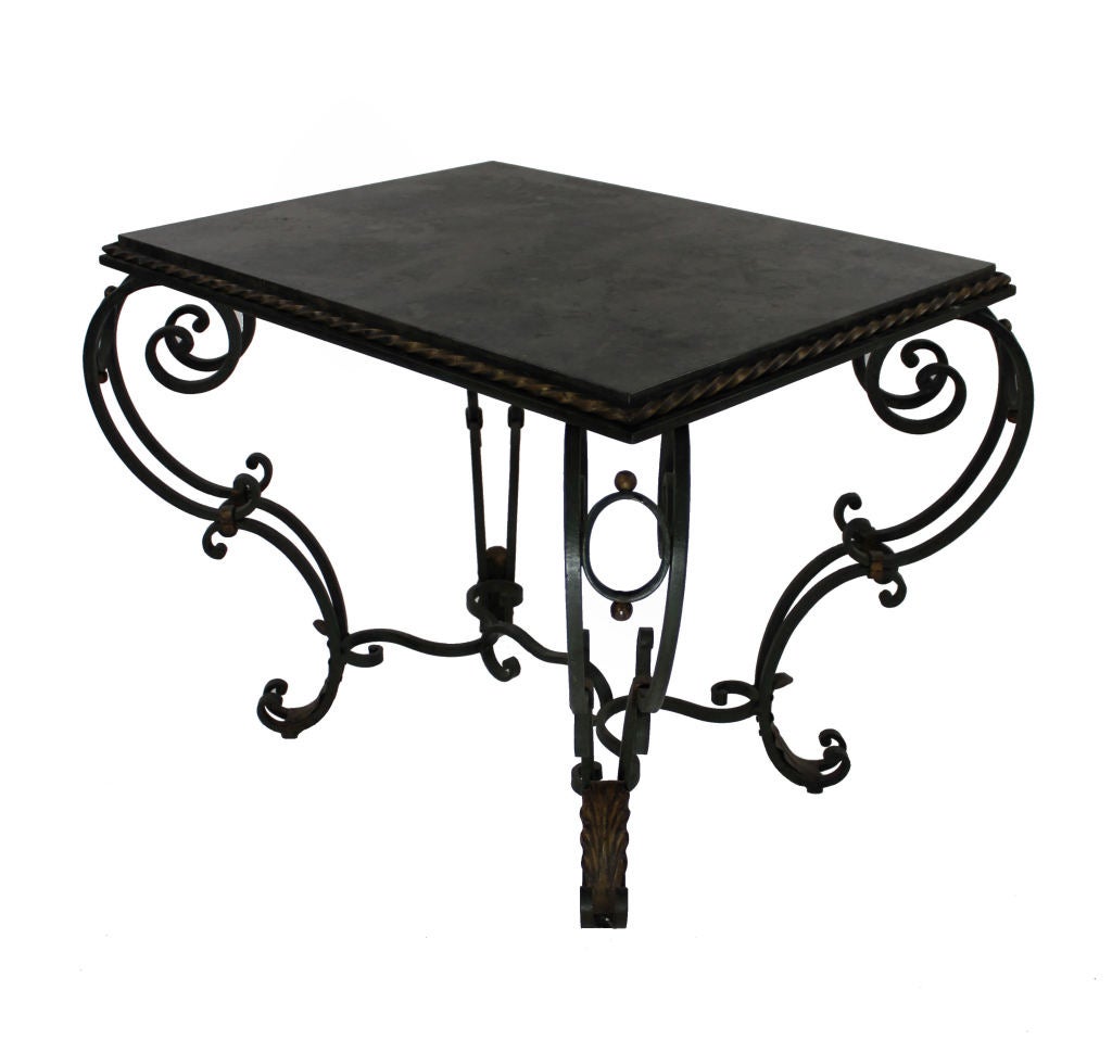 A French painted and gilded wrought iron occasional table with a polished blue-limestone top. The paint is a very dark green.