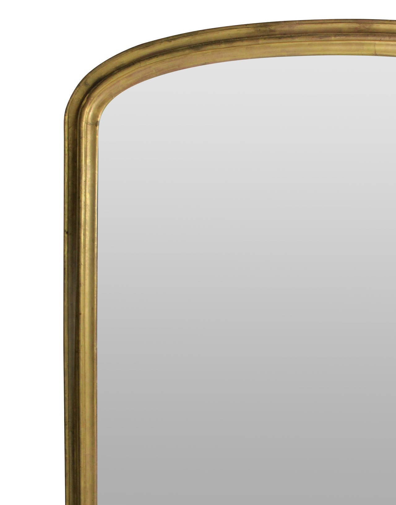 A large French carved and water gilded overmantel mirror with scrolled detailing at the bottom and arched frame. Original plate.