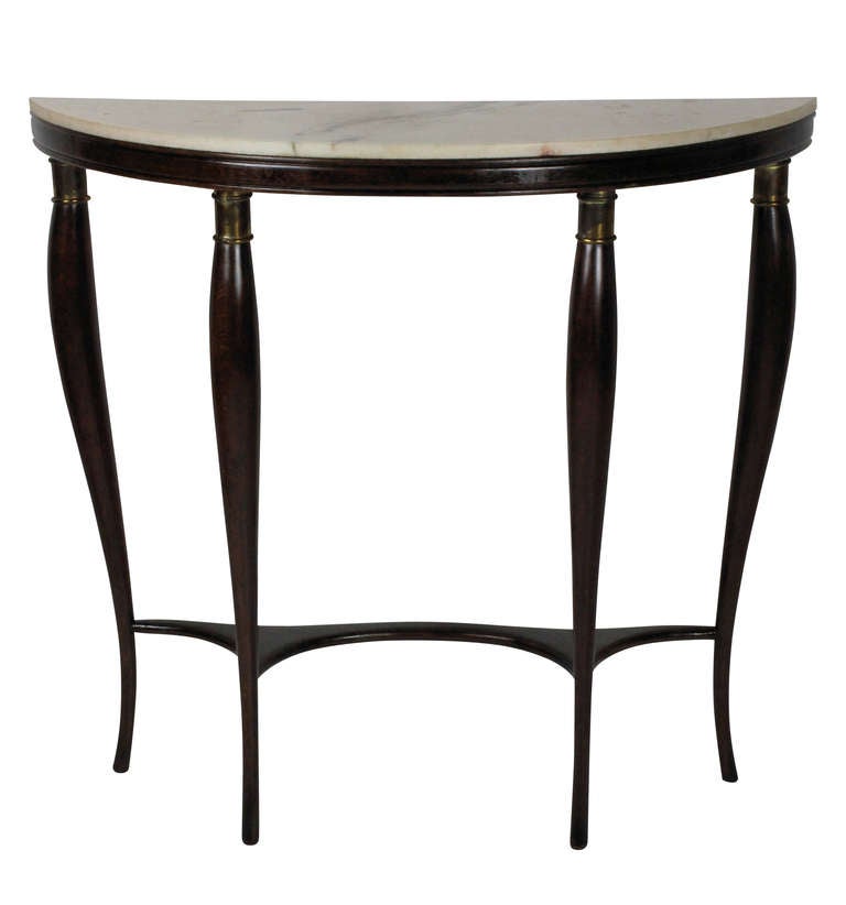 An Italian hall demi lune console of interesting shape in dark wood, with brass fittings and a marble top.