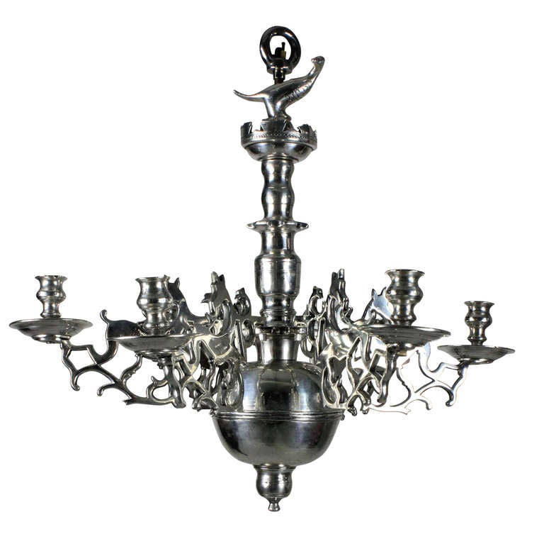 A Flemish chandelier in silver plated brass with drop in arms depicting birds, bulbous stem and stylised bird at the top.