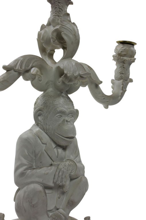 A French carved wood and white lacquered three branch monkey candelabra.