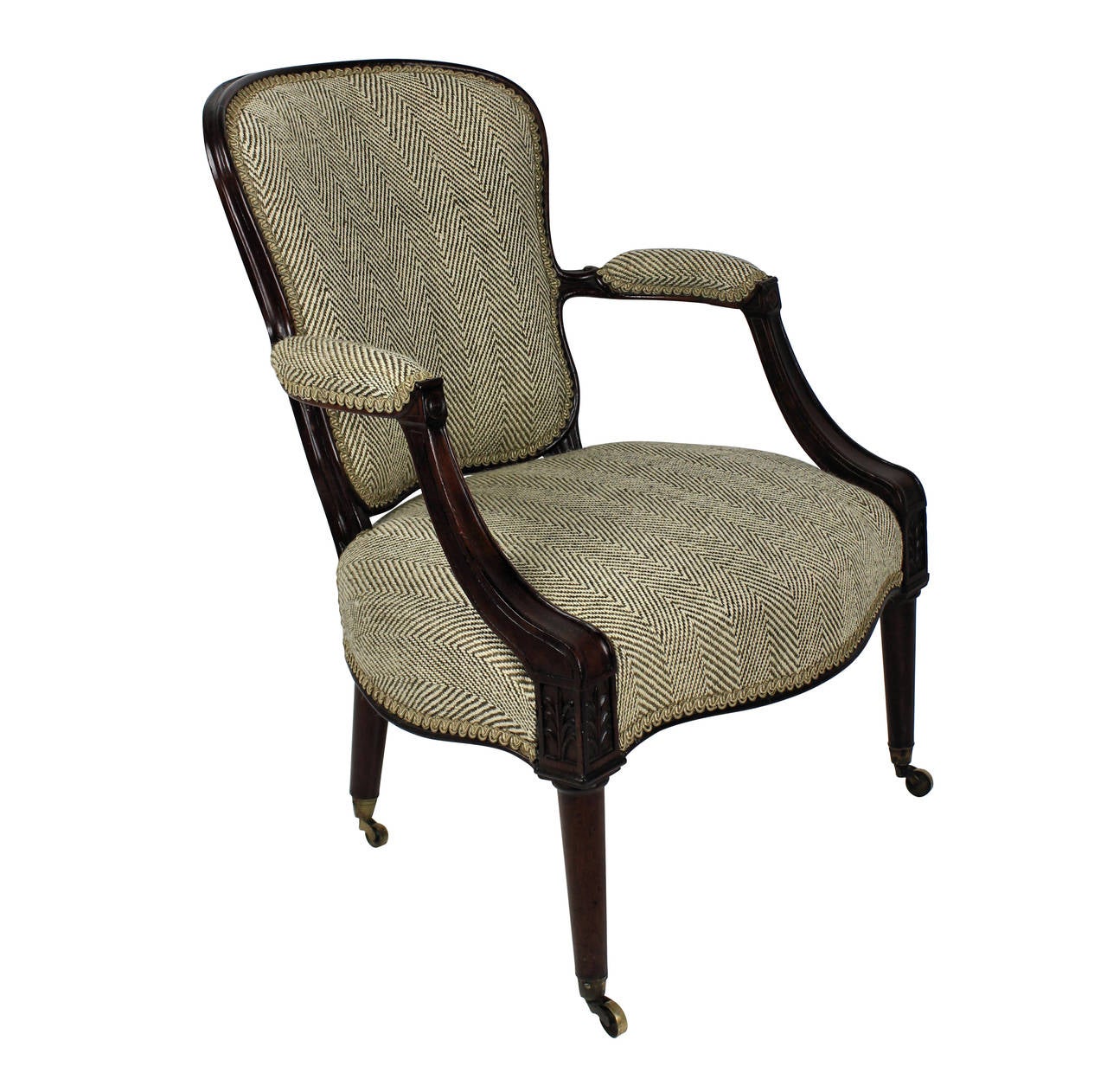 An English mahogany Hepplewhite armchair, with finely tapering back rail and arms with acanthus decoration. With horsehair upholstery and on brass casters.