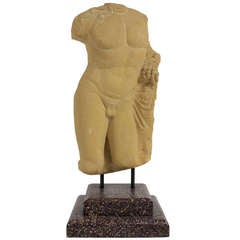 A Carved Stone Figure Of Bacchus On A Faux Porphyry Plinth