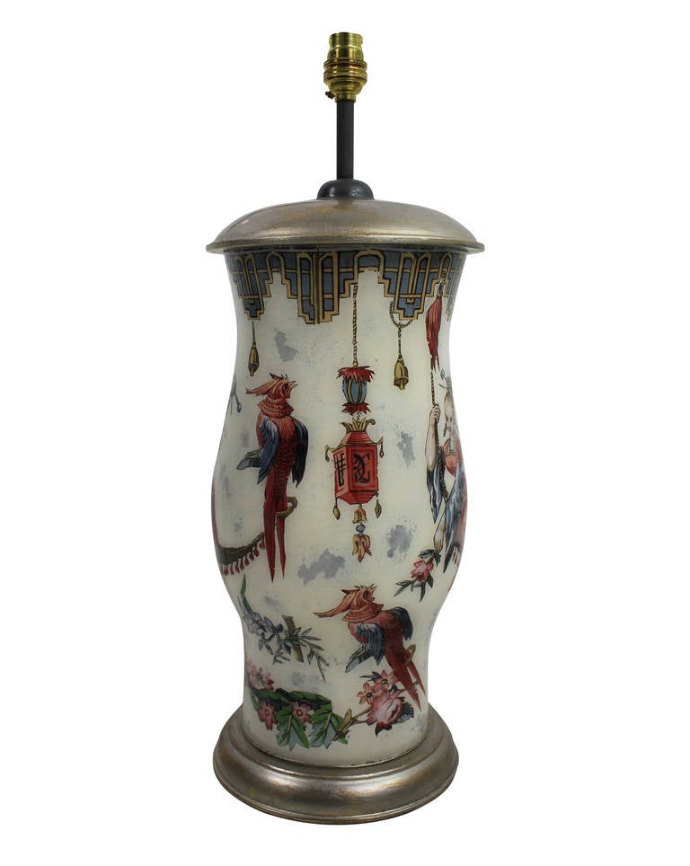 A pair of declamania hand painted table lamps inspired by Oriental designs of the Regency period. With white gold leaf tops and bases.