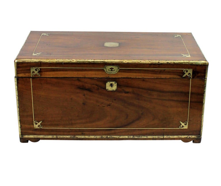 An English George III campaign chest in fragrant smelling camphor wood. Of good proportions, well inlaid with brass and fitted with load bearing carrying handles.