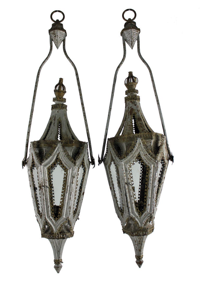 A set of four English Gothic hanging lanterns of tapering form. Each glazed with panels and a door. Later painted and still for candle use but can be electrified.
