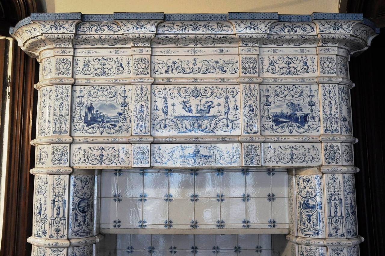 This antique 19th century stove was made out of ceramic. The decor is rich made of shades of blue on a white background. The decor is composed with landscapes, chimeras and grotesques.
The fireplace is signed by the painter "A Jean."
The