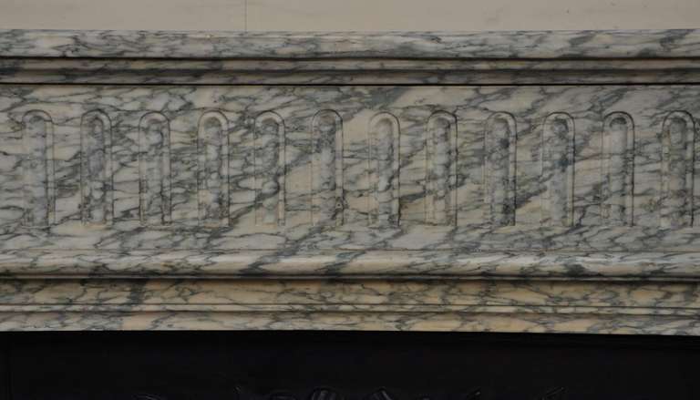 The Green Campan marble is highly prized for its aesthetic qualities. The fireplace was made in the late 19th century, in France. The central frieze is slightly curved and is ornated with fluting.The jambs ,are also fluted and curved in its upper