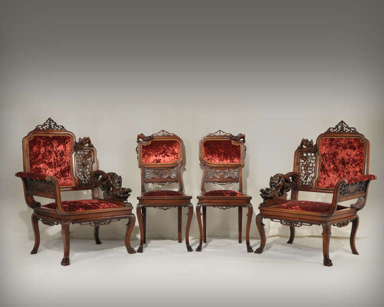 This salon set includes two chairs and two armchairs made in the late 19th century by Perret and Vibert, owners of the Maison des Bambous in Paris. Inspired by the Far East, this living room furniture is richly carved with dragons and latticed
