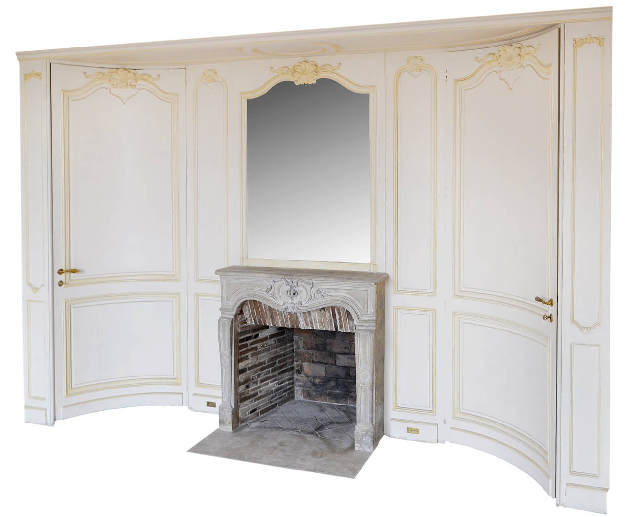 This paneled room element is curved. Made in the early 20th century, this Louis XV style paneled room was made in the spirit of Jansen. 
The fireplace is a Louis XV period stone mantel. Beautiful details in the carvings.