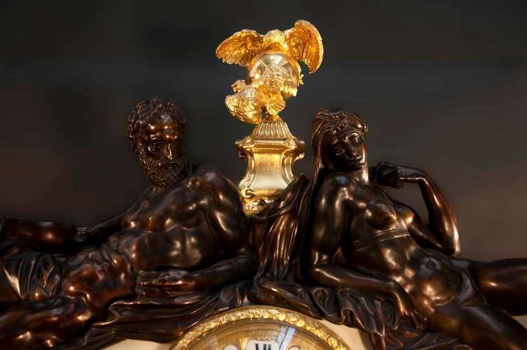 This exceptional and monumental clock was made out of Statuary Carrara marble, gilded bronze, and brown patina bronze in the late 19th century. Realized in a Neo-Renaissance style, the two bronze characters are made after the model by Michelangelo