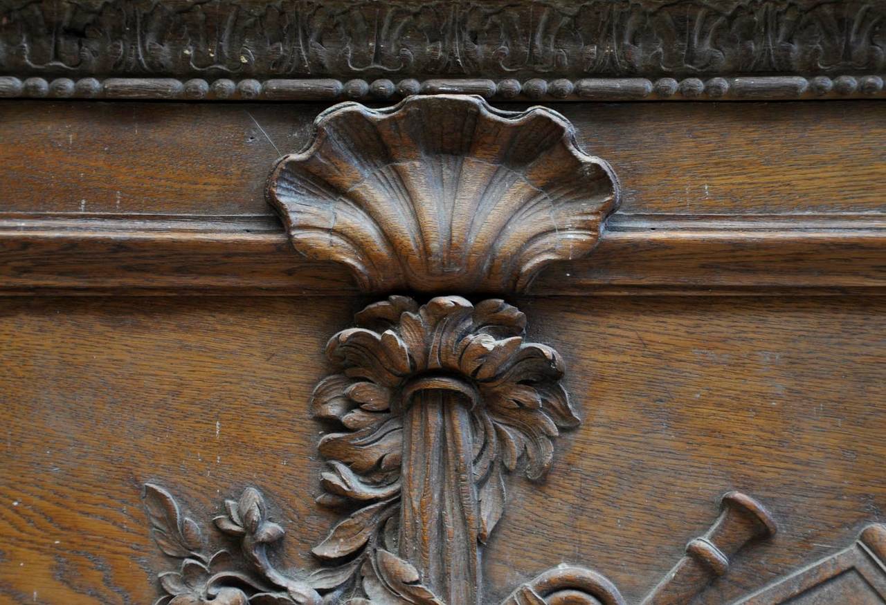 This antique door pediment was carved in oak wood during the 19th century. In the Louis XVI style, the pediment is ornated woth music instruments, branches and foliages. 
High quality of the carvings decor.