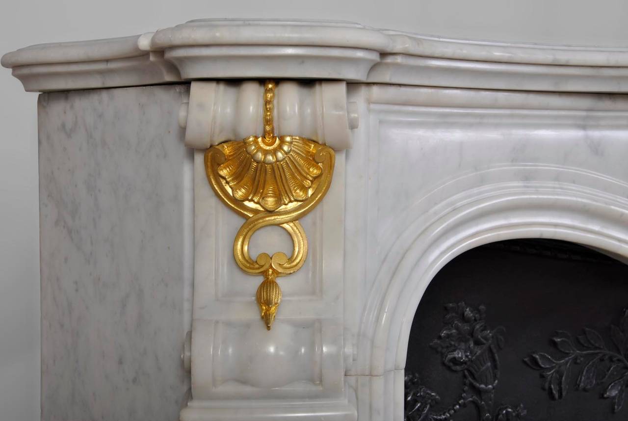 Carved Louis XV Style White Carrara Marble Fireplace with Gilded Bronze Ornaments