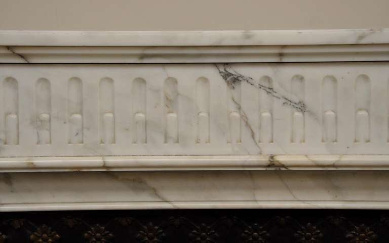 This antique Louis XVI style fireplace mantel was realized in a semi statuary Carrara marble in the 19th century. The banner and the jambs are decorated with grooves. The heads of the jambs are decorated with square rosettes.
This fireplace is sold