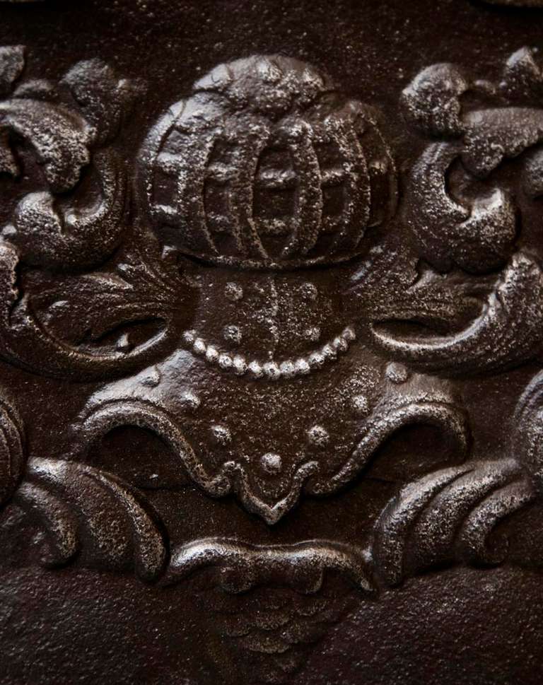 This rare and beautiful antique cast iron fireback was made in the 18th century. 
An unknown coat of arms is represented, surmounted by an helmet.
The same model is exposed in the Museum of Orleans and documented in the book by Henri Carpentier