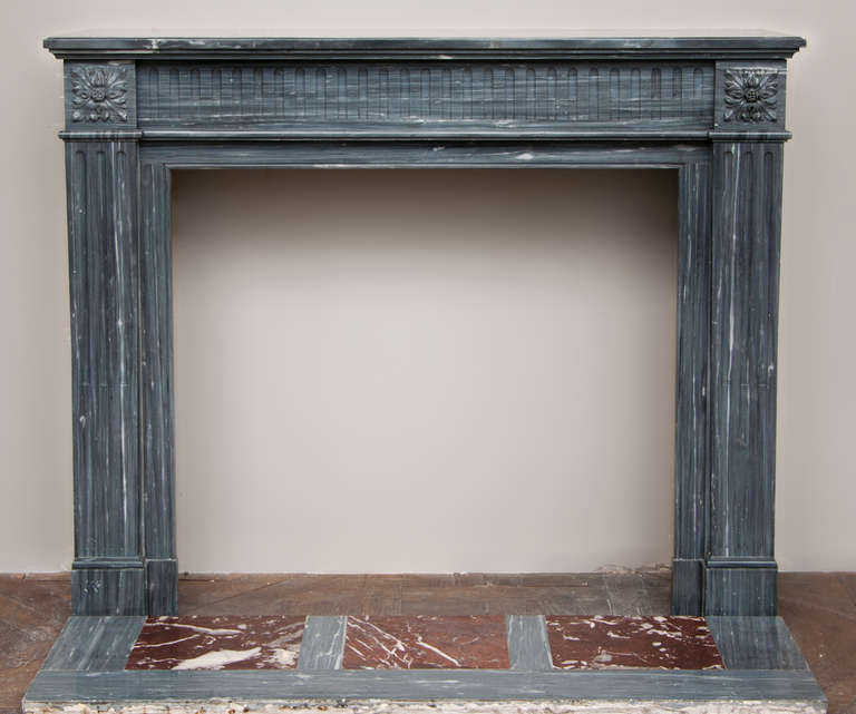 Antique Louis XVI style fireplace made out of Bleu Turquin marble