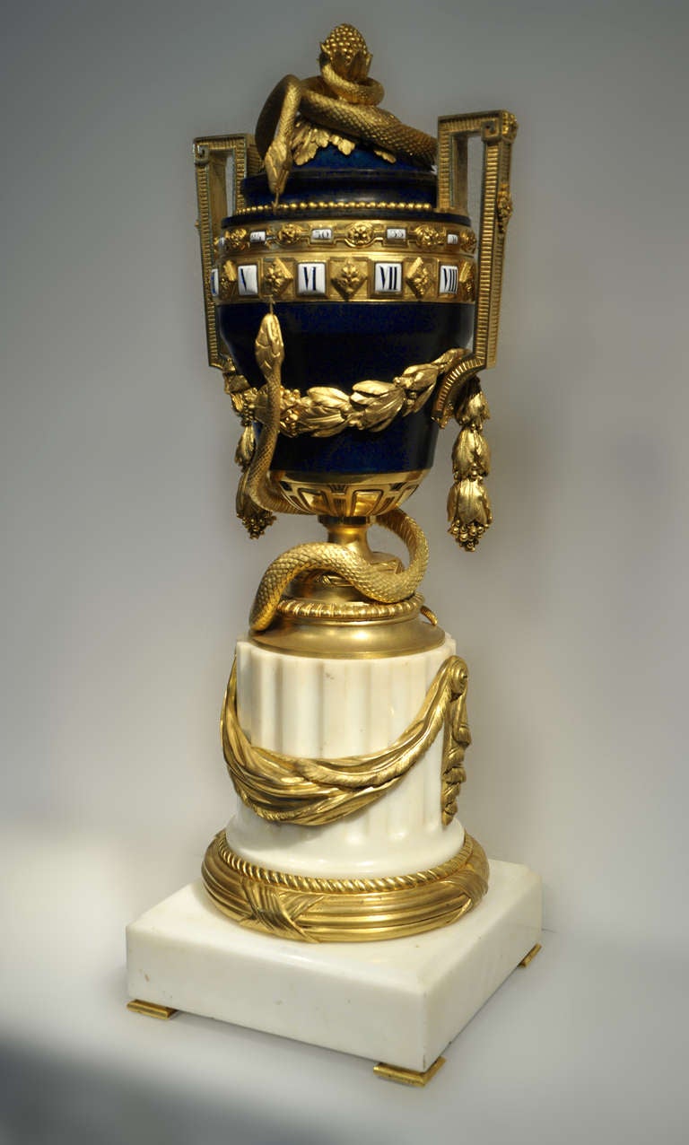This exceptional and rare antique clock was realized in the mid-19th century, in Paris. Made out of Statuary marble, gilded bronze and blue lacquered metal, this model with rotary dial is inspired from some 18th century models. One is now kept in