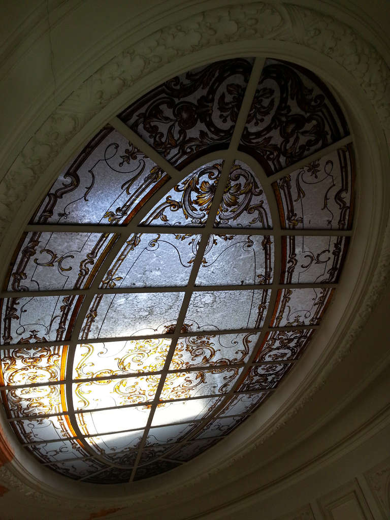 This antique Neo-Renaissance style stained glass ceiling was made during the 19th century. Oval shape, the stained glass is richly decorated with foliate scrolls, flowers and palmettes of Renaissance inspiration.