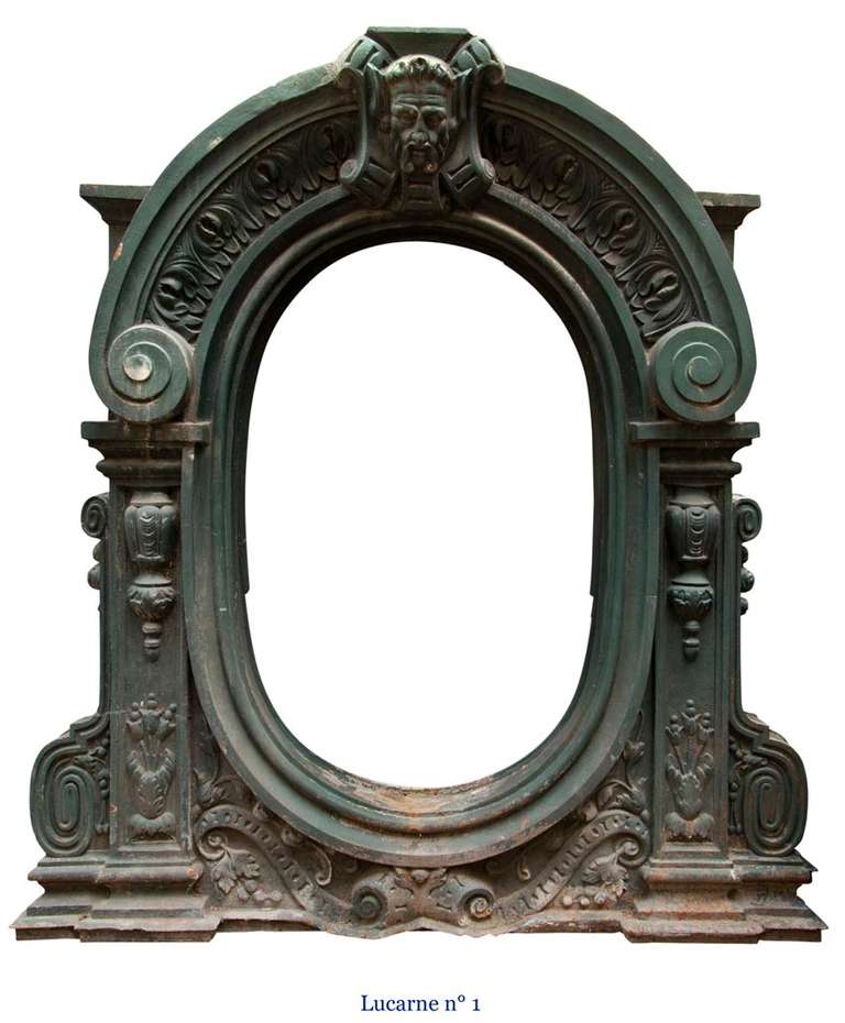 This rare pair of attic windows was made out of cast iron in the 19h century. Napoleon III style, these windows has large dimensions. The decor is highly sophisticated : Satyrs heads in low relief, windings, palmettes, and foliages.