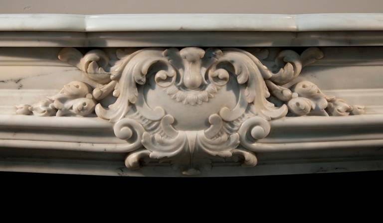 Period: 19th century. The sculpted decoration of this fireplace is rich. Sides are curved and panneled.
A modern cast iron insert is included but there is no marble floor. This one could be made to order.