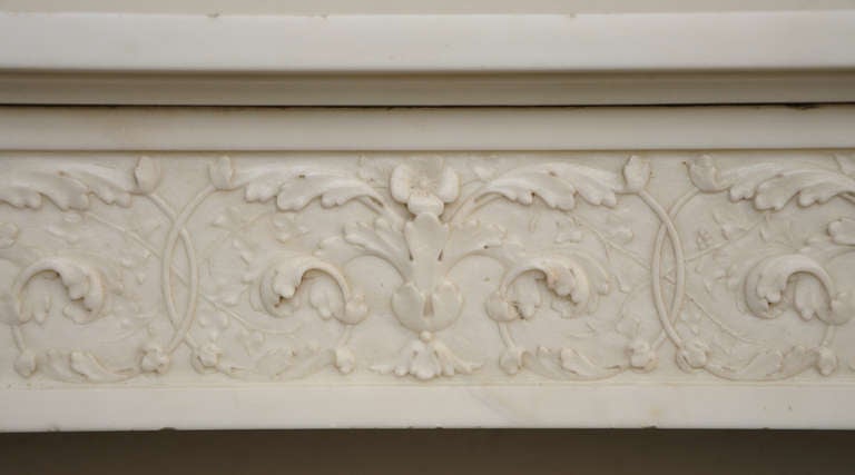 This antique Louis XVI style fireplace was realized in an exceptionnal statuary Carrara marble. This model is rare and really beautiful : the detached columns are fluted and crowned bu windings capitals underlined by a row of pearls. 
The frieze