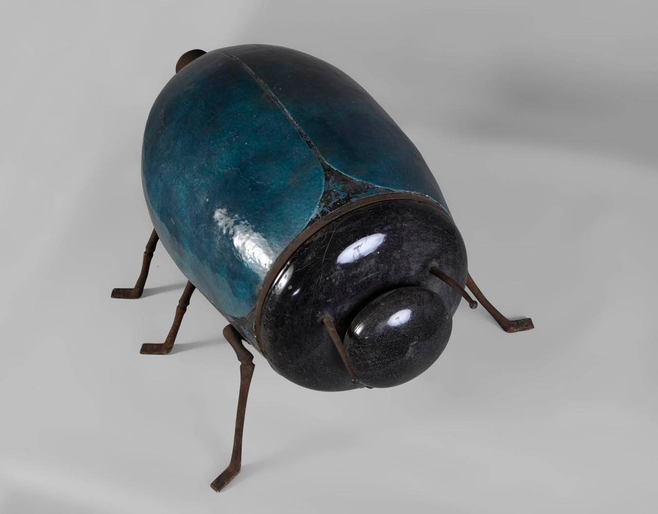 This rare enameled cast iron stove was realized in the late 19th century in a form of a scarab. 
Both parts of the head can be removed. 
Inscription: 