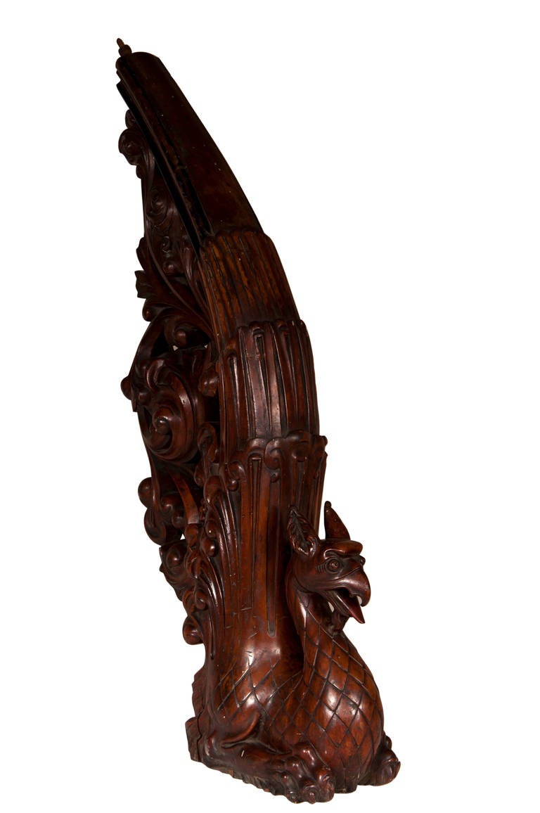 This rare and original stair banister was made out of mahogany wood circa 1910. The carvings are of exceptional quality. A griffin is carved in the round has a fantastic bird. Its tail unfolds in height to give birth to the banister. The openwork
