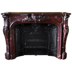 Beautiful antique Louis XV style fireplace in Red Griotte marble, 19th c.