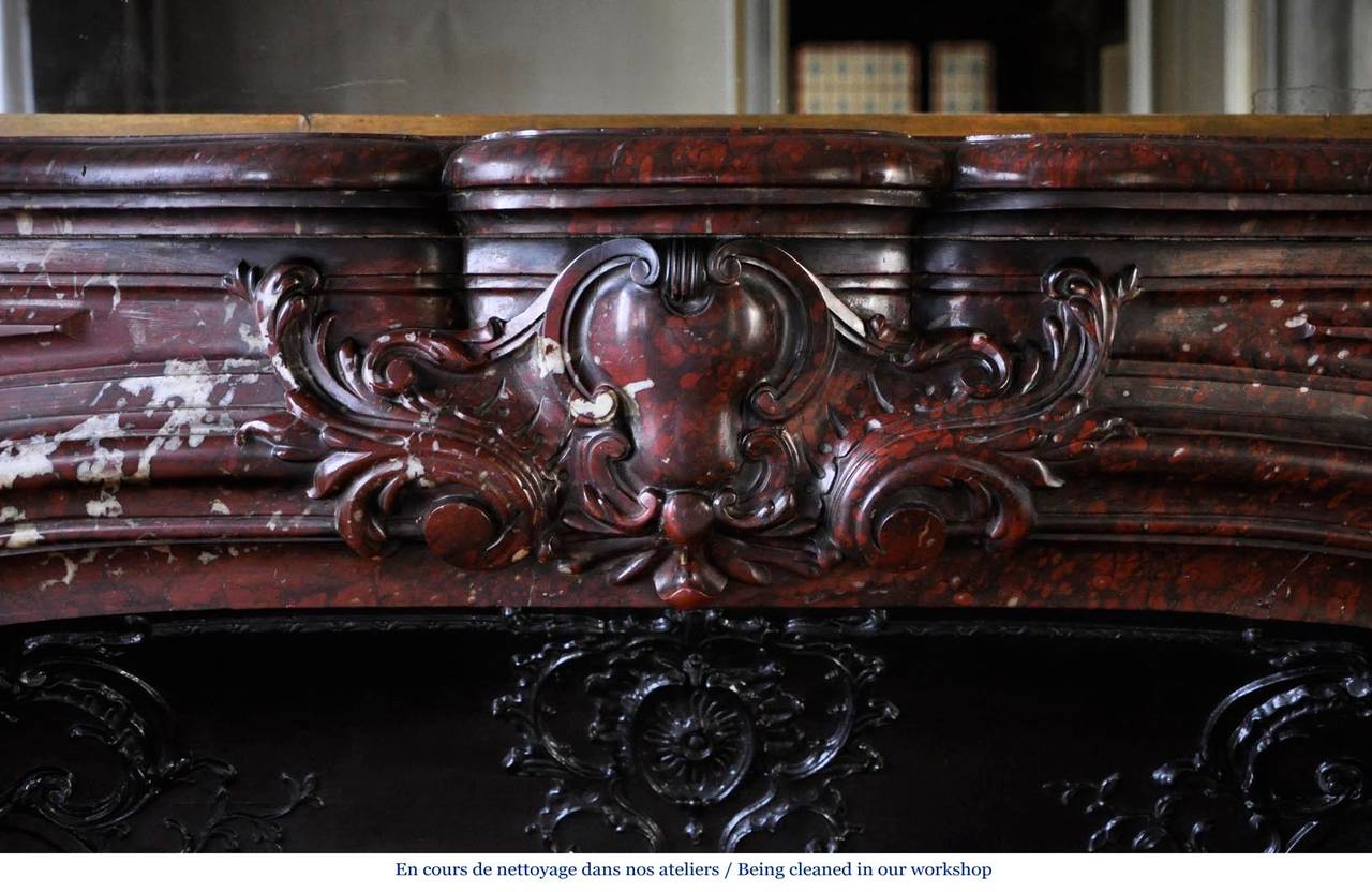 Beautiful antique Louis XV style fireplace in Red Griotte marble, 19th c.