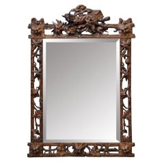 Antique mirror with a wolf in carved walnut wood