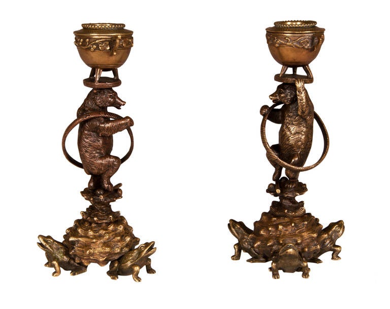 This pair of gilded bronze candlesticks is attributed to Christophe Fratin. The base is composed with three frogs. Circus bears carry the candlestick on their heads.
