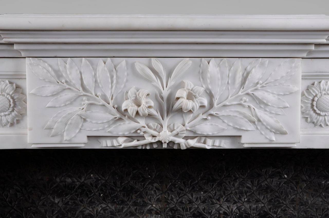 This exceptional antique Louis XVI style fireplace was made out of Statuary Carrara marble during the 19th century. The fireplace has been made after the fireplace which is kept in the Salon de Compagnie in the Petit Trianon at the Versailles Palace
