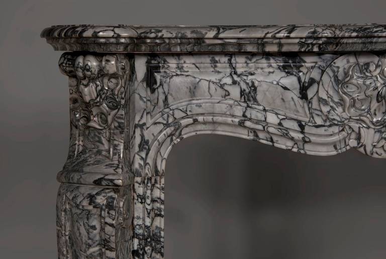 Carved 19 th century: Louis XV style three shells fireplace, Bleu Fleuri marble