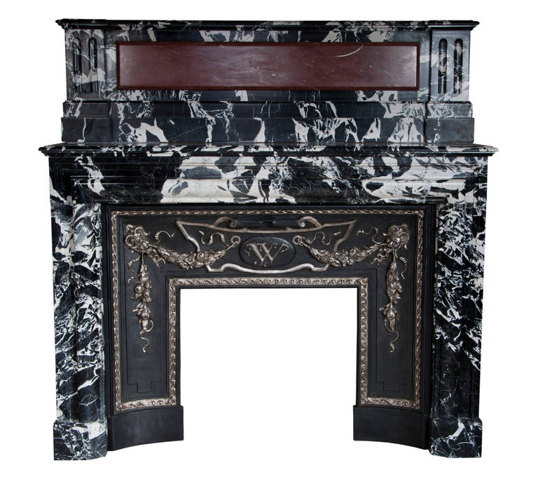 This exceptional Louis XIV style fireplace was made out of Grand Antique marble during the 19th century. A large Red Griotte cabochon ornates the upper part of the fireplace. 
Grand Antique marble is exceptional, rare and highly sought. 
This