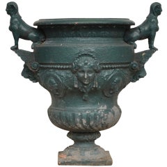 Antique cast iron vase with two sphinxes