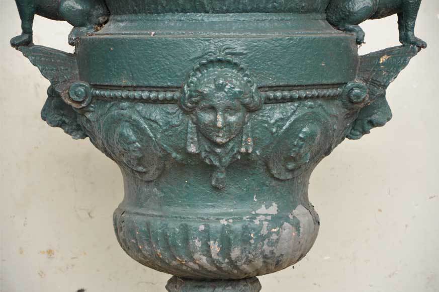 This antique cast iron vase for the garden was realized in the 19th century. It's decorated with two sphinxes on each sides and a beautiful head of women on the paunch.