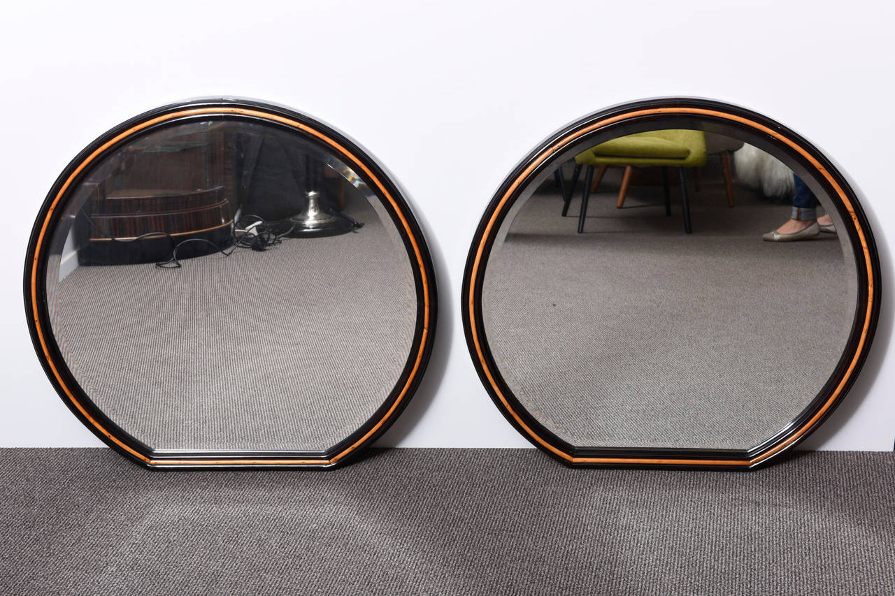 A very nice  art deco mirror, made in tinted ashwood, refinished with a lustrous hand made French polish. The contrast of the light and dark rosewood colored frame makes the mirror very elegant. 
Italian origin from 1930.