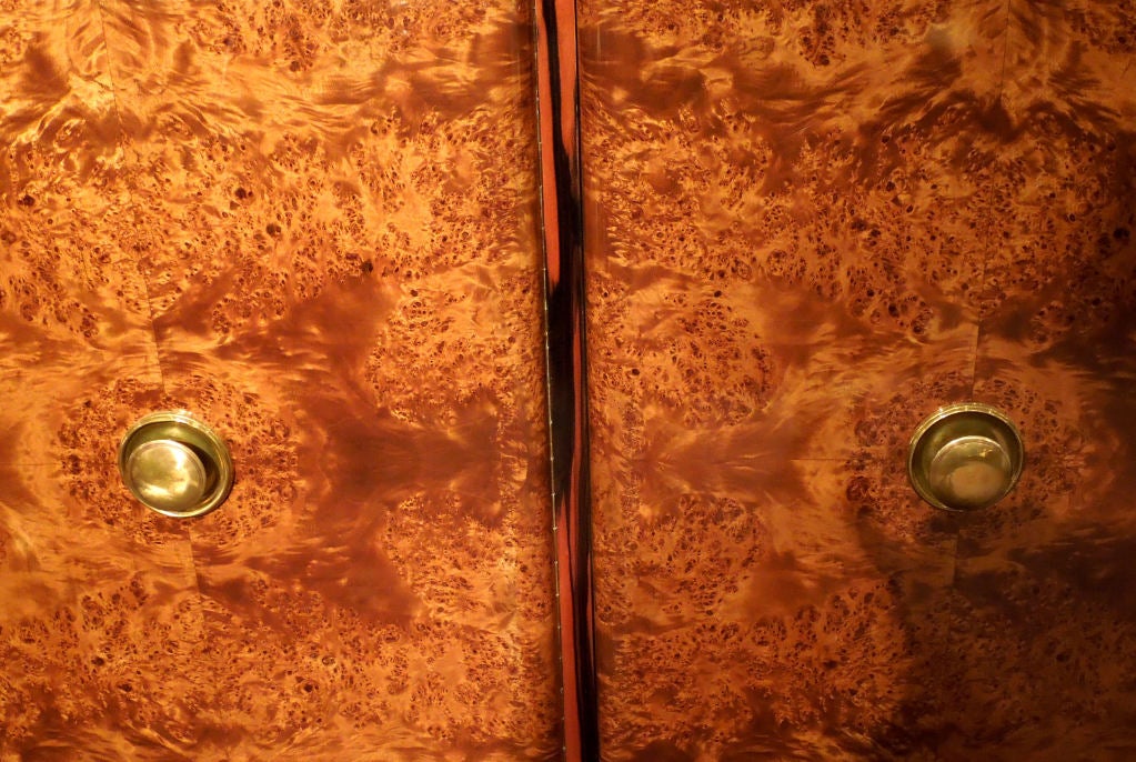 A very high quality art-deco credenza in walnut and  ebony macassar .Nice  proportion sideboard with three doors,a drawer and a shelf behing each.Brass hadware.On the left hand side a beautiful vitrine with sliding glass doors.