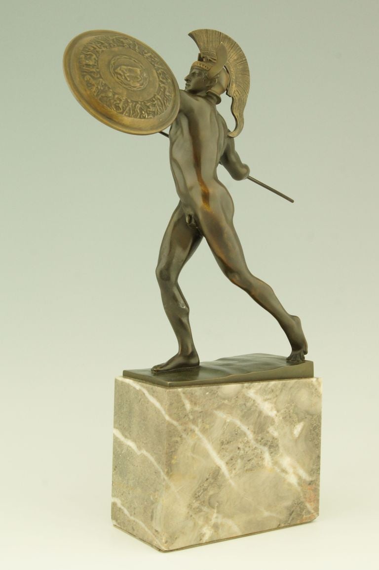 This antique bronze is depicting Achilles with spear and shield. 
The work is signed by the German artist Wilhelm Wandschneider (1866-1942) 
Information about the artist can be found in:
“Bronzes, sculptors and founders” by H. Berman, Abage.