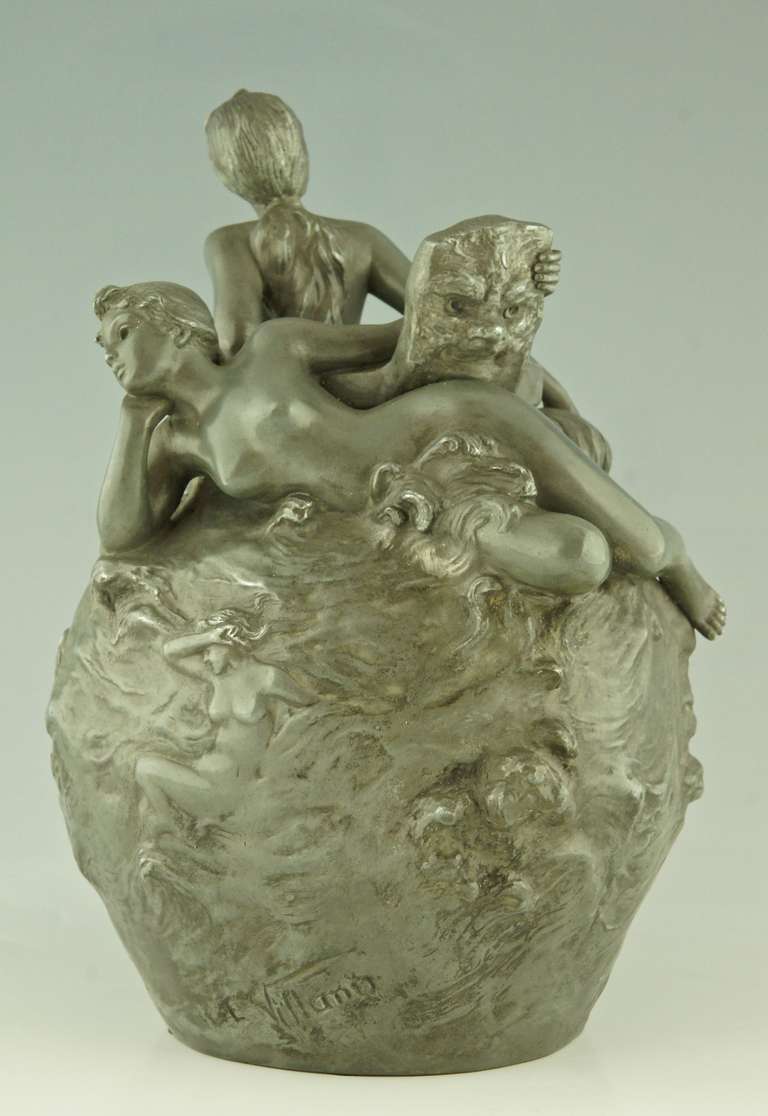 Title:  “Meditation”
Description:  Pewter vase depicting two nudes, one is holding a mask in her hand.  The surface of the vase is decorated with nudes and waves. 
Artist: Emmanuel Villanis (1858-1914)
Signature:  E. Villanis. 
Style:  Art
