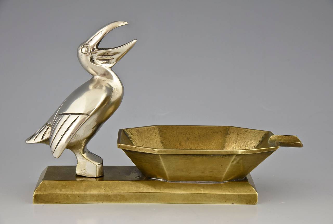 Art Deco bronze ashtray with pelican.
By A. Marionnet
Signature & Marks:  A. Marionnet  France
Style:  Art Deco.
Date: Ca. 1925.
Material:  Bronze and silvered bronze. 
Origin:  France.
Size:			 
H. 4.9 inch x L. 7.5 inch. X W. 2.8 inch.
H.