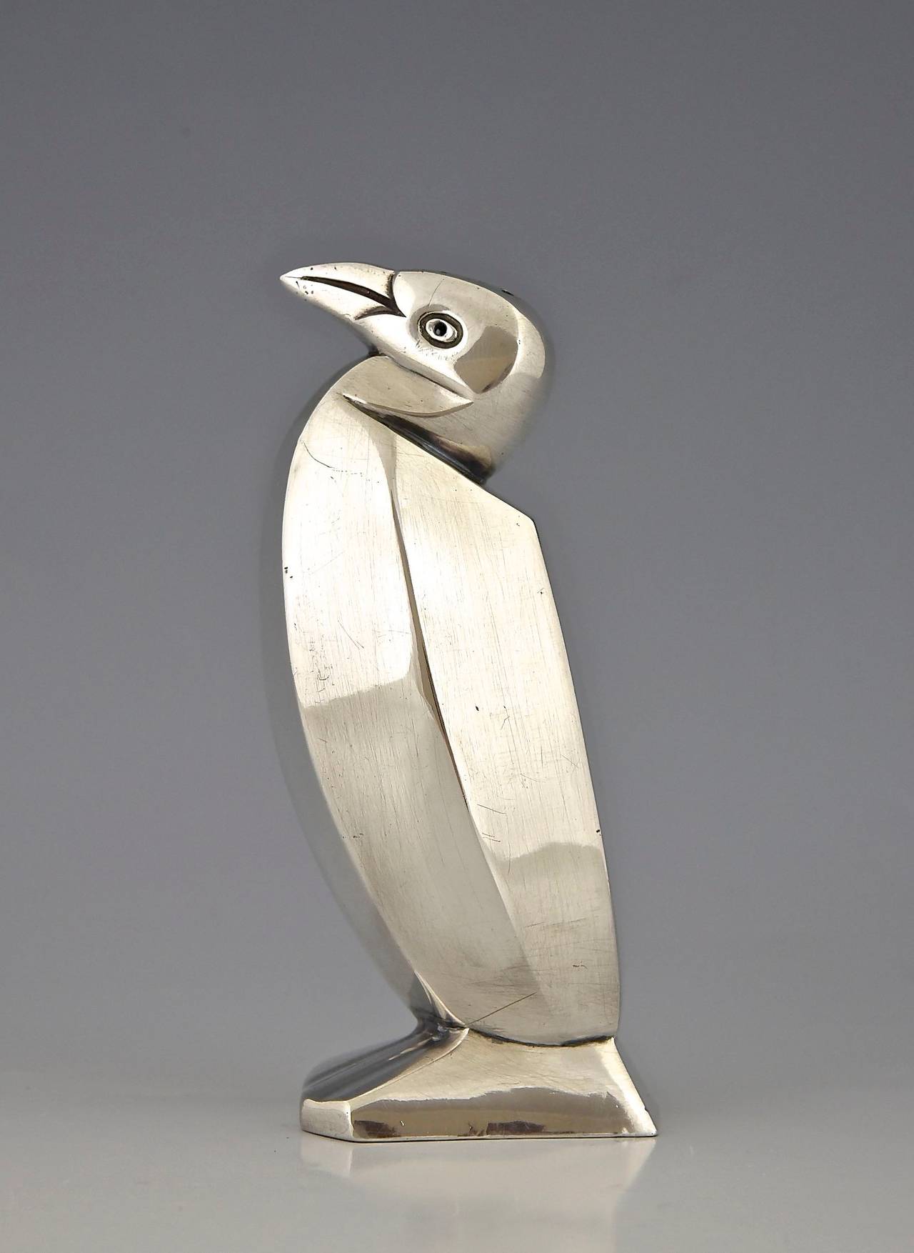 Art Deco salt or sugar dispenser in the form of a penguin.   Artist or Maker:  Christofle. Design by Sandoz. 
Signature and marks:  Christofle stamped mark.  Modelnumber.
Style:  Art Deco. 
Date:  1935. 
Material:  Silvered metal. 
Origin: 