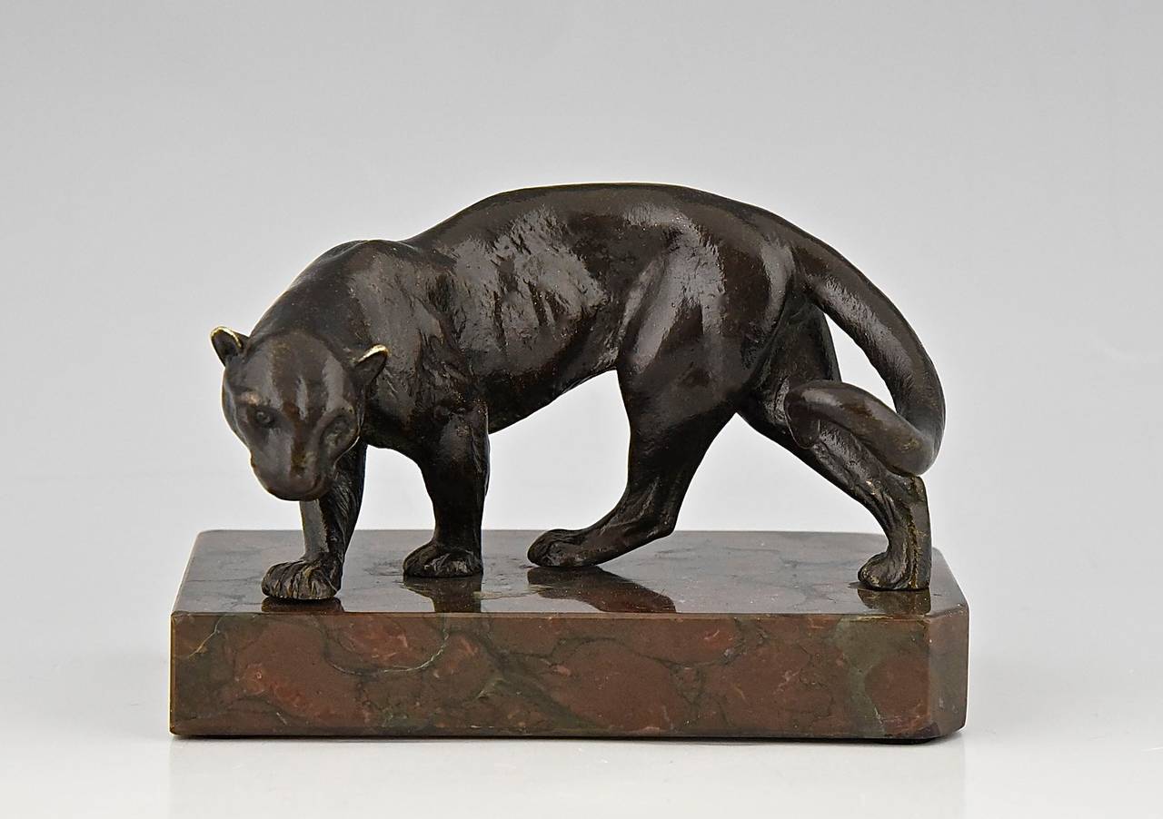 A Vienna bronze panther sculpture, can be used as a paperweight
Artist:  Bergmann, Fr.   
Signature: Bergmann seal, B in vase. 		
Date:  1900.			
Material: Patinated bronze.  Marble base.	
Origin:  Austria. 			
Size:			 
H 3.5 inch x L. 4.9