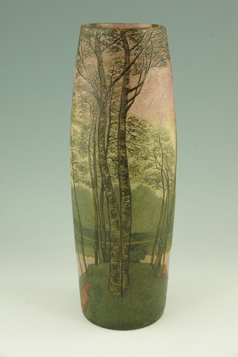 Art Nouveau cameo glass landscape vase with enamel. It has a decoration of trees along a river.  
The colors are pink, green and brown by Legras &Cie. 

Literature: 
“Glass, art nouveau to art deco” by Victor Arwas, Academy. 
“Lampen und