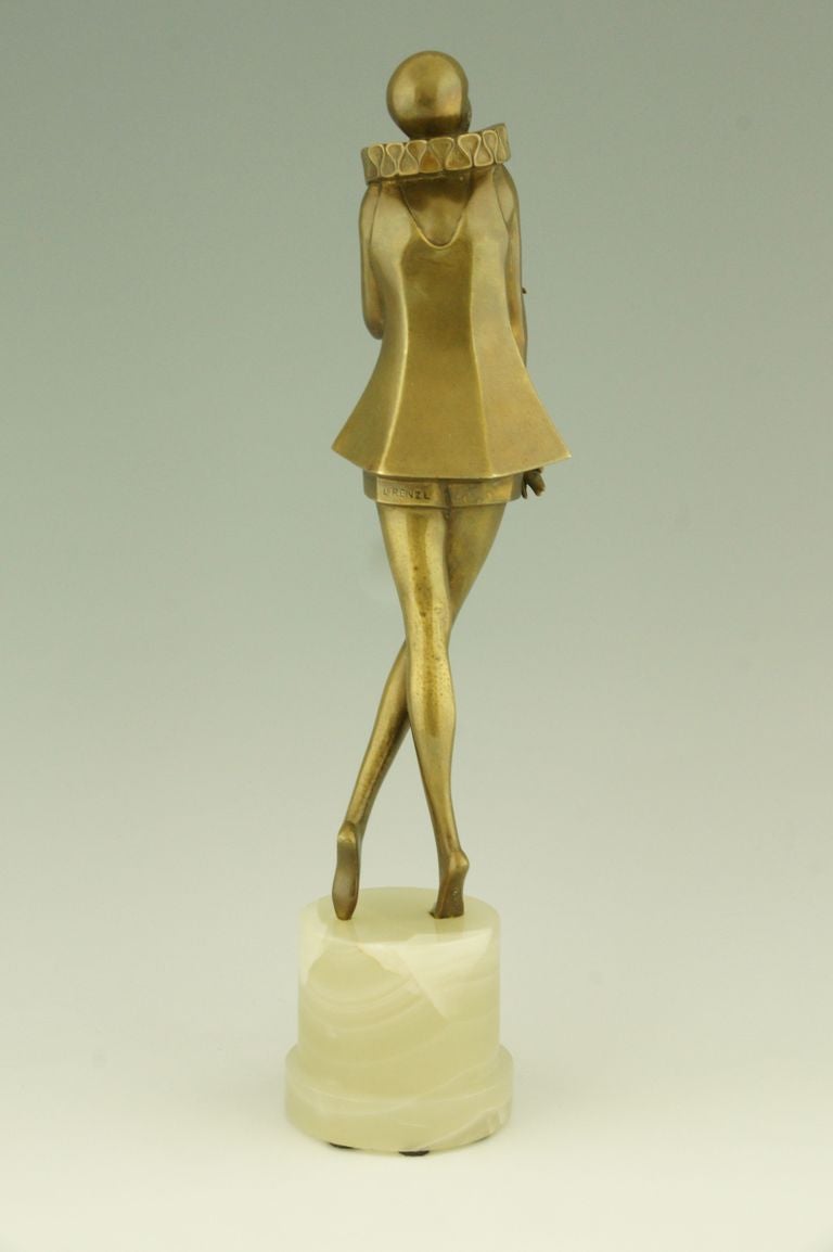 20th Century Art Deco bronze sculpture of a woman with stylized costume by Lorenzl. 