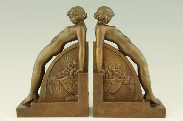 A pair of Art Deco bookends with nudes.  
The center has a relief decorated vase with flowers.  
By François Victor Bazin. 
Signed F. Bazin.  Foundry Edts. Albert Buisson.

Literature:
“Mascottes passion” by Michel Legrand, Antic show