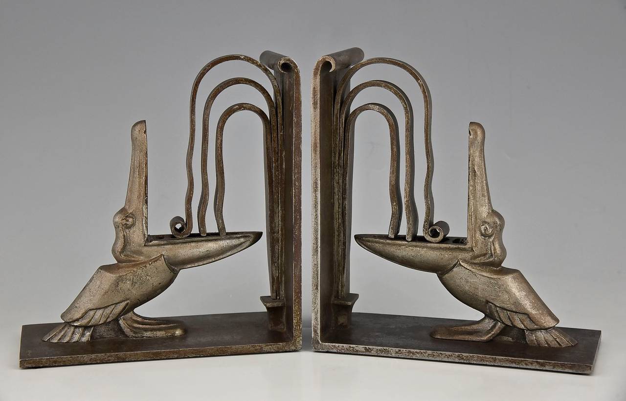 A pair of Art Deco wrought iron pelican bookends. 
By Edgar Brandt.
Stamped E. Brandt.
Style:  Art Deco.
Date:  1924. 
Material: Cast and wrought iron. 
Origin: France. 
Size:
H. 6.7 inch x L. 6.1 inch x W. 3 inch.
 H. 6.7 inch x L. 6.1